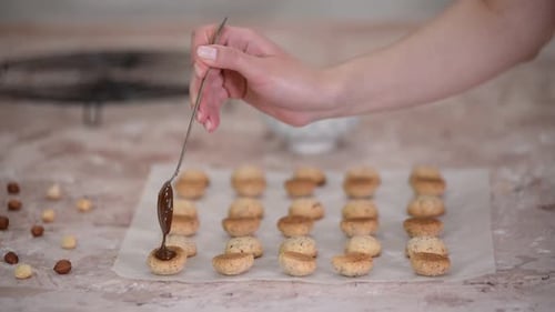 Decorating Hazelnut Cookies with Chocolate