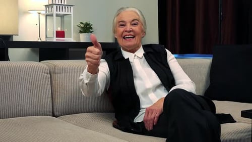 Adult Giving Thumbs-Up From Couch in Living Room