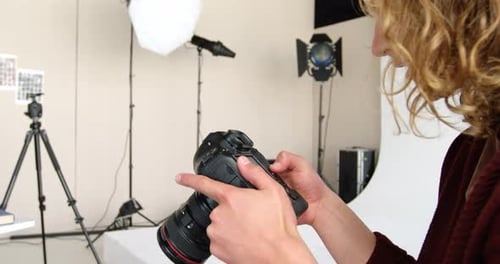 Person Using Camera in Studio with Lighting