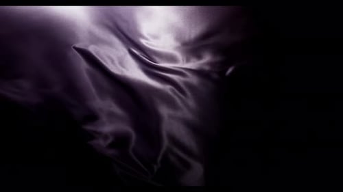 Dark Satin Fabric Flowing Abstractly in Darkness