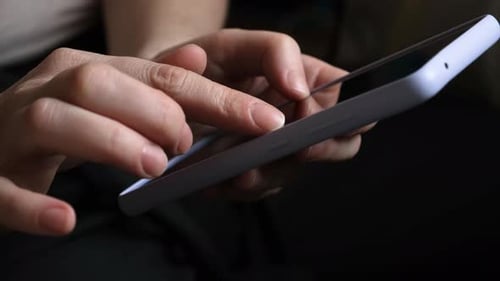 Hands Interact with Smartphone Touchscreen in Close-Up