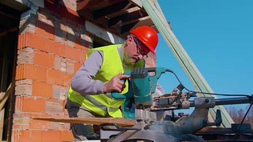 Construction Worker Using Electric Saw on Job Site