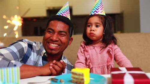 Dad and Girl Celebrate Birthday with Sparkler and Cake