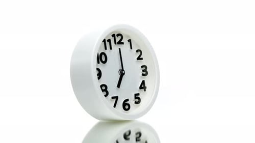 White Alarm Clock Showing Seven O'clock Spinning Rotating 360 Isolated on White