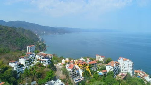 Aerial View of Tropical Coastline Houses and Ocean