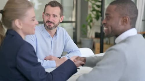 Positive Business Meeting with Handshake in Modern Office