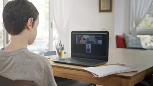 Child Attends Online Class at Home on Laptop