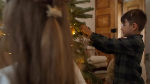 Children Decorating Christmas Tree with Ornaments