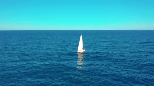Aerial View. Yacht Sailing on Opened Sea. Yachting with Sails Up at Windy Day.