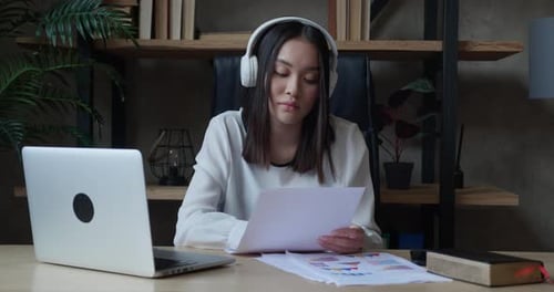 Happy Asian Girl with Headphones College Student Using Laptop Computer Watching Distance Learning