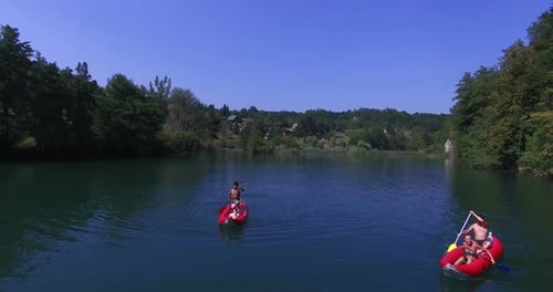 Aerial view of friends having fun paddling canoe on Mreznica river, Croatia