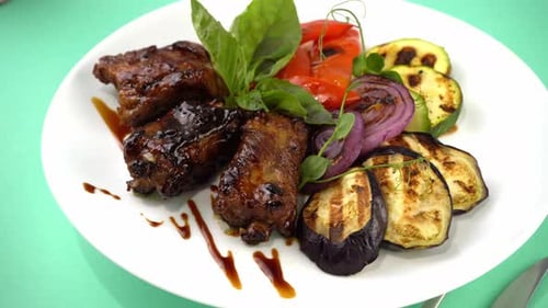 Close Up of Plate of Ribs and Vegetables
