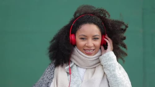 Woman Listening to Music With Headphones Outside