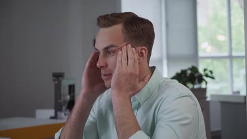 Businessman Has Headache at the Office