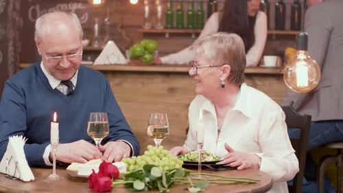 Cheerful Senior Couple on a Romantic Date in a Restaurant