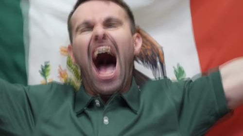 Man Cheers Wildly in Front of Flag