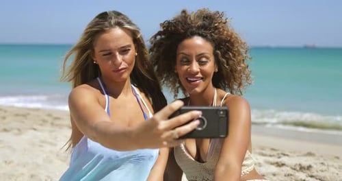 Playful Women Posing for Selfie on Beach