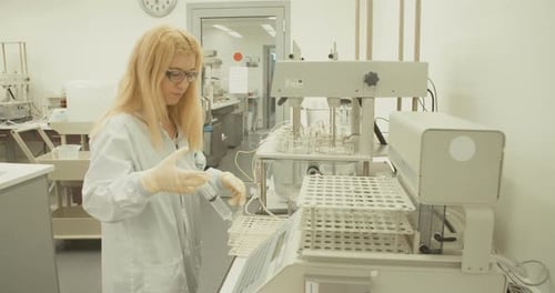 Woman Scientist Working With Syringe in Bright Laboratory