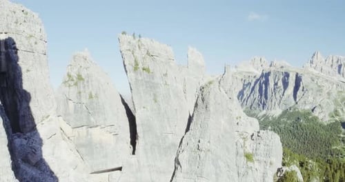 Aerial Flight Above Mountain Top with Pines and Rocks in Sunny Day