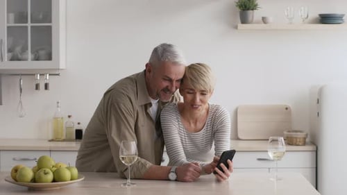 Senior Couple Smiling Together in Modern Kitchen