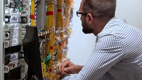 Technician Working on Servers in Data Center