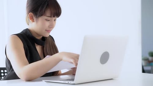 Woman Working on Laptop in Bright Office