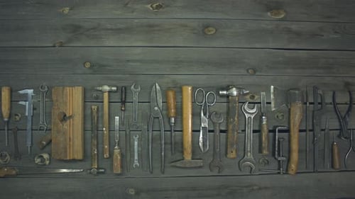 Antique Hand Tools Arranged on Rustic Wood Background