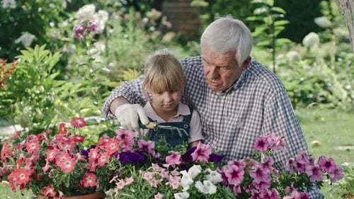 Child and Senior Gardening Together in Vibrant Garden