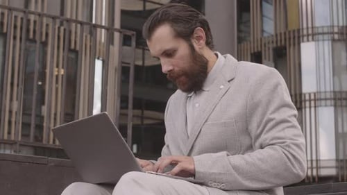 Man Working and Talking on Phone in City