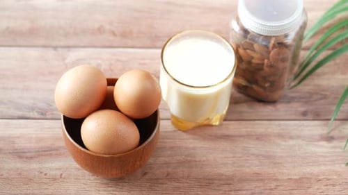 Eggs, Milk, and Almonds on Wooden Table