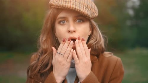 The Shocked Young Pretty Woman in a Forest. The Pretty Female Is Looking at the Camera and Is