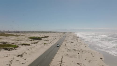 Fly Above People Travelling By Cars on Road Passing Through Sand Coast