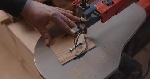 Woodworking at the Workshop Carpenter Uses Automatic Jigsaw and Cuts Small Plywood Parts