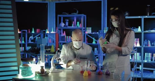 Scientists Conducting Experiments in Dark Futuristic Laboratory