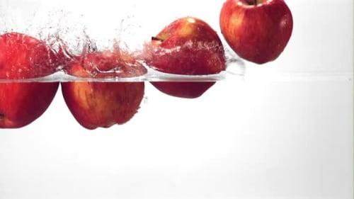 Apples Falling into Water Creating a Splash