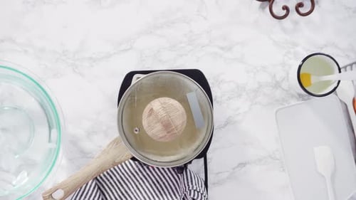 Time lapse. Flat lay. Step by step. Caramelizing sugar in a small cooking pot