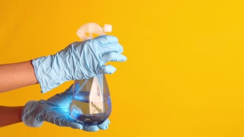 Hands With Gloves Use a Spray Bottle