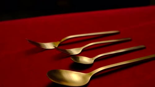 Gold Cutlery on Red Background