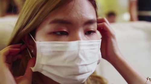 Traveler Wearing Face Mask While Traveling on Commercial Airplane