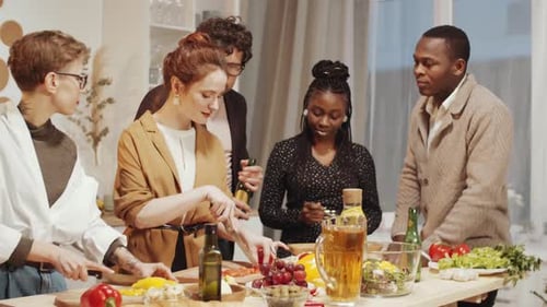 Friends Prepare Food Together in Kitchen