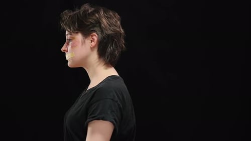 Woman with Bruises and Tape over Mouth Says Violence