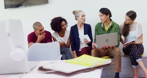 Coworkers Collaborating on Project in Office Space
