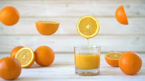 Fresh Orange Juice and Oranges on Table