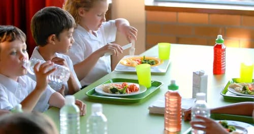 Kids having meal in cafeteria