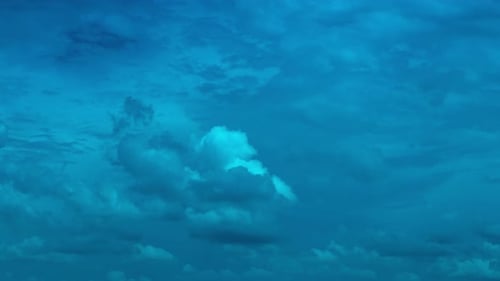 Fluffy Clouds Moving Gently Across Blue Sky