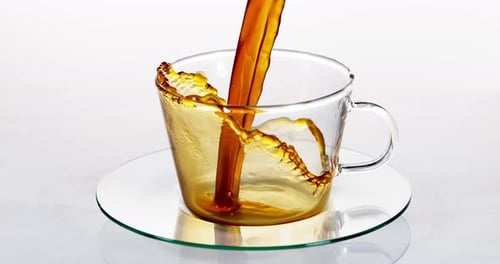 Dramatic Pour and Overflow of Amber Liquid