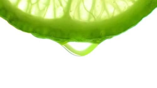 Fresh Slice Lime, a Drop of Water Falls The Fruit Gives Off Freshness and Juice Filling. Concept of