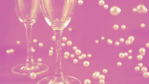 Champagne Glasses and Pearls on Pink Backdrop