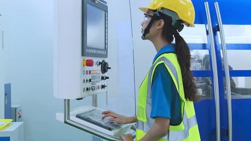 dolly shot of young female technicians work manage inspecting with control screen