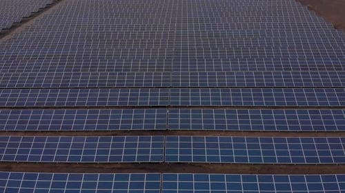 Aerial Drone View Into Large Solar Panels at a Solar Farm. Solar Cell Power Plants. Footage Video .